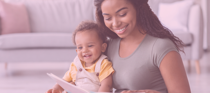 a person is reading to a baby while sitting on the floor