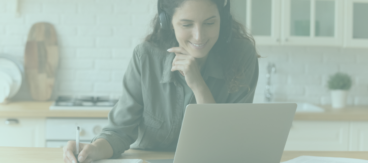 a person is working on their laptop while sitting at the kitchen table