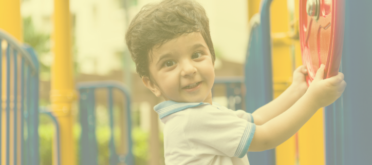 A child is playing on playground equipment