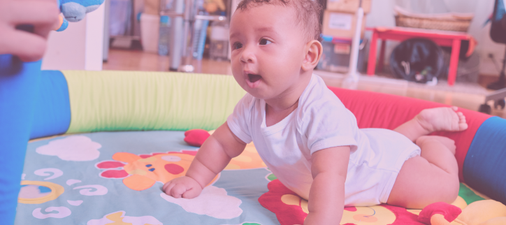 a baby is playing on a play mat in a room