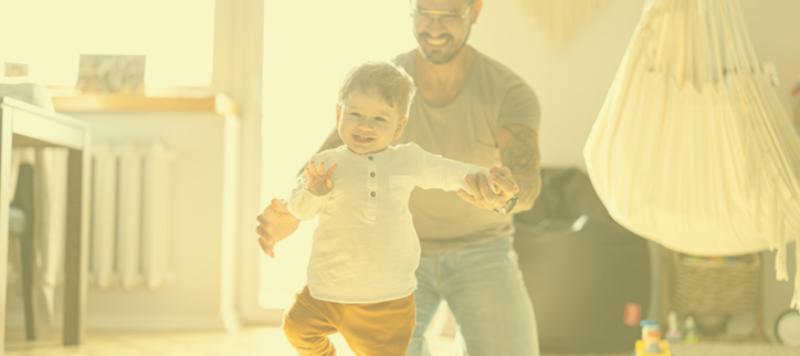 Dad and child playing in a living room