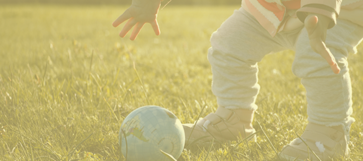 a child playing with a frisbee in a field