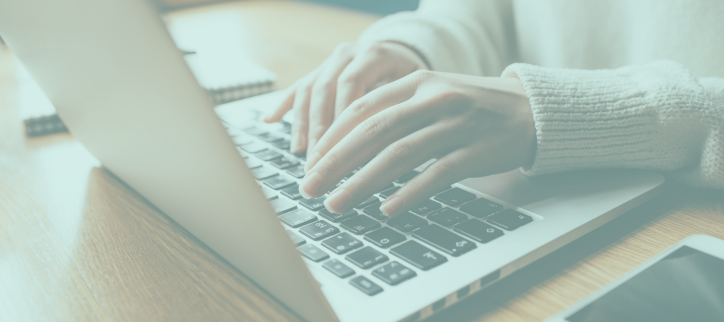 a person typing on a laptop computer