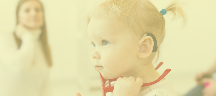 a child with a hearing aid on their left ear