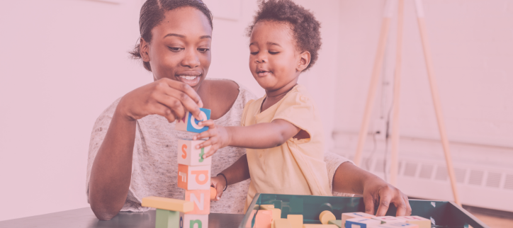 A woman and her child playing with blocks