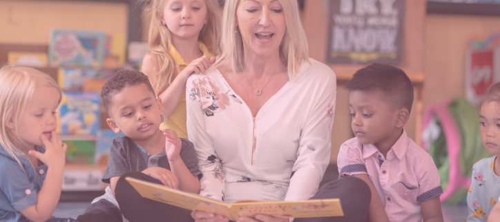 a person reading to a group of children in a classroom