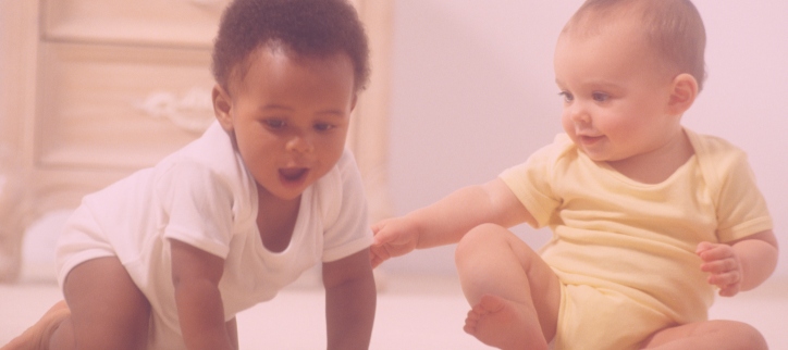 two babies playing on the floor