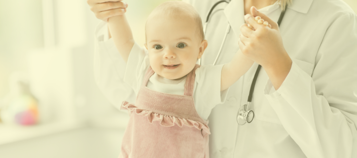 Doctor holding infant in the doctor's office